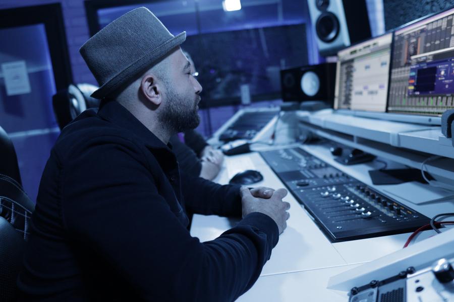 Engineer working at the desk during a mastering session