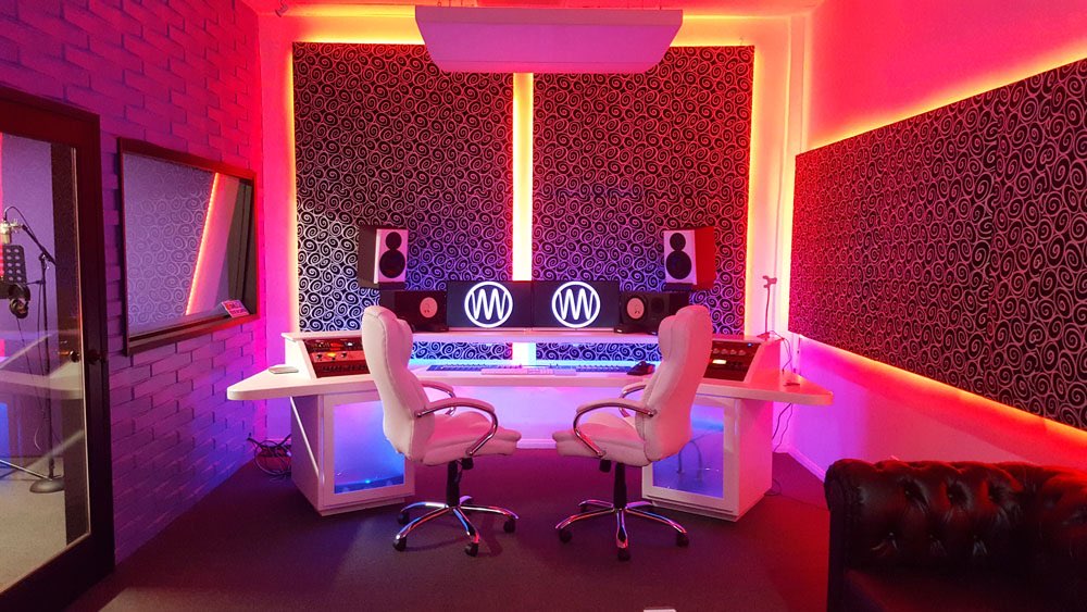 Best recording studios near me - MIX Recording Studio Control room with white mixing desk, studio monitors and pink LED lighting at MIX Recording Studio in Los Angeles